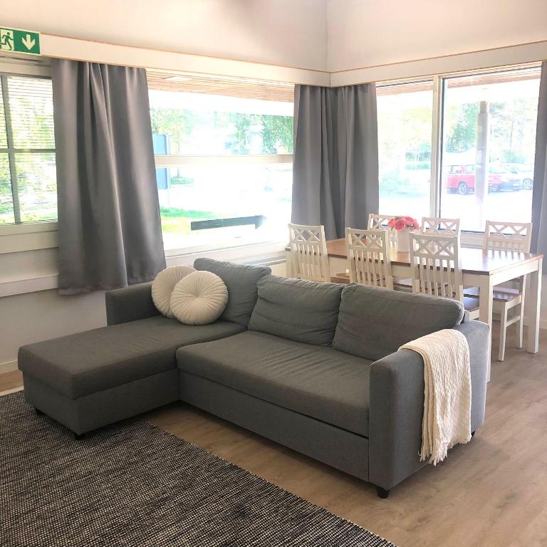 a living room with a couch and a table at Pohjoiskeskus 9 in Oulu