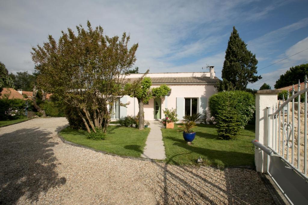 une maison blanche avec une clôture et une cour dans l'établissement Proche de Bordeaux et Saint Emilion, maison au calme avec grand jardin, à Salleboeuf