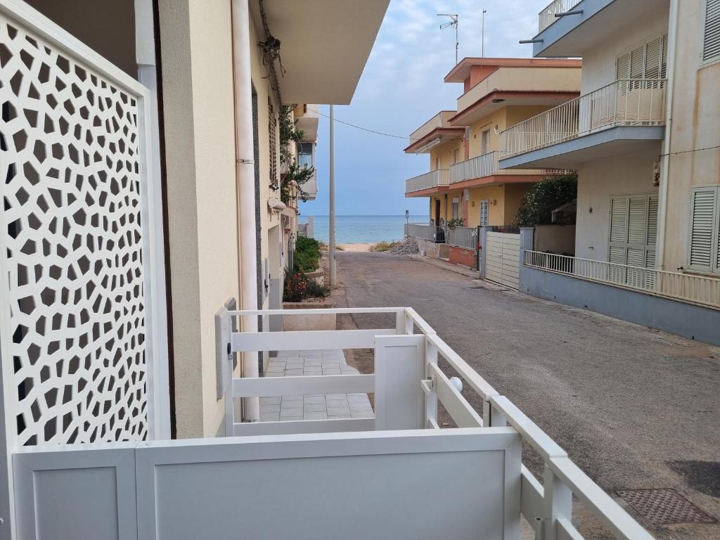 a balcony with a view of the ocean at AM-MARE in Villaggio Azzurro