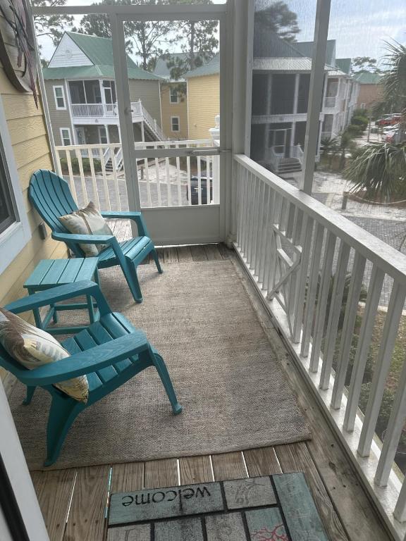 two chairs on a porch with a view of the ocean at Island House 1Bu By Pkrm in Pensacola