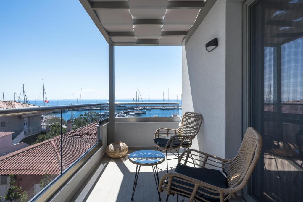 a balcony with chairs and a table and a view at Nikiti Summer Gem 1 by Luxlikehome in Nikiti