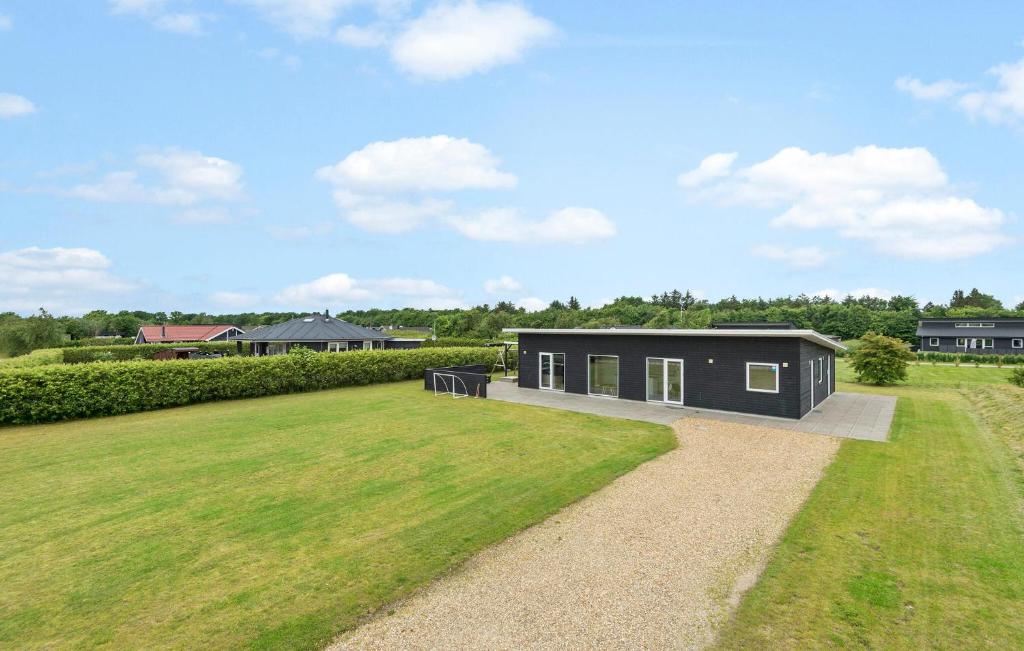 a small black house with a large yard at Pet Friendly Home In Hemmet With Wifi in Hemmet