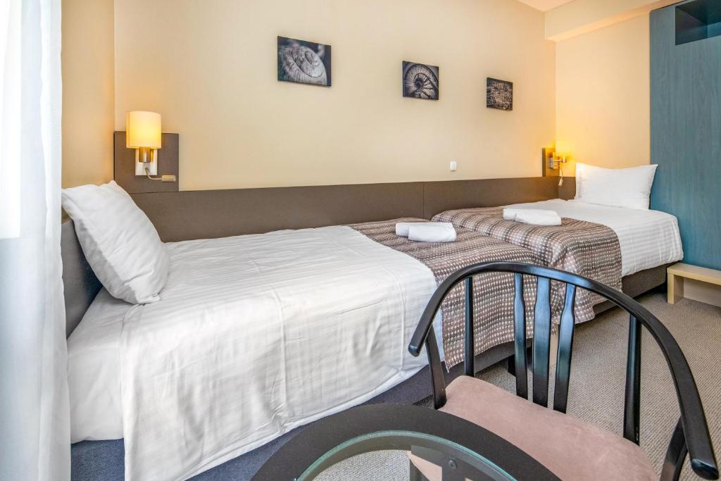 Postel nebo postele na pokoji v ubytování Corvin Hotel Budapest Corvin Wing