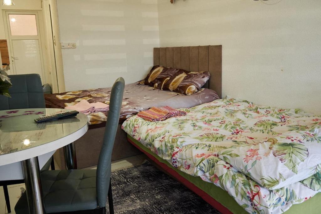 a bedroom with a bed and a table and a table and chair at Apartman Lili in Ohrid