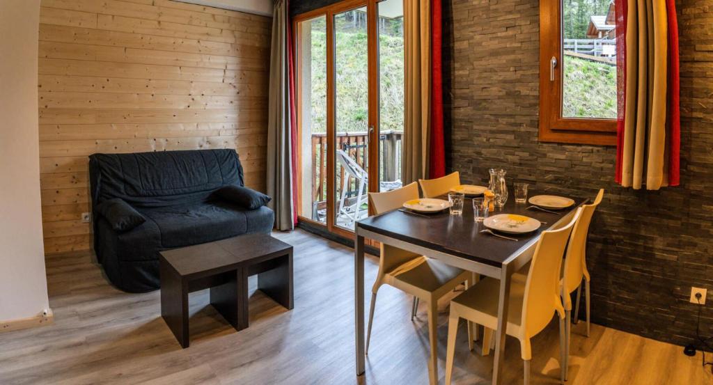 une salle à manger avec une table et une chaise dans l'établissement Résidence Les Terrasses Du Soleil D'or - Studio chaleureux au pieds des pistes MAE-1281, aux Orres