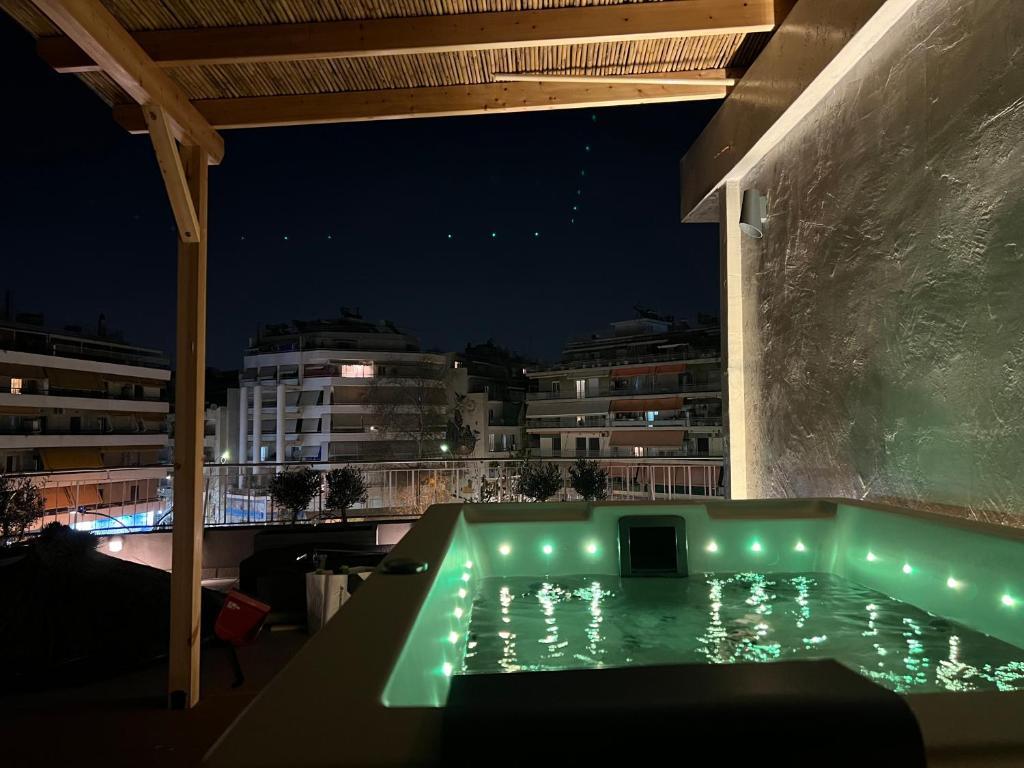 a swimming pool on the roof of a building at night at Athens Top Penthouse Apartment With Spa 5' to Metro in Athens