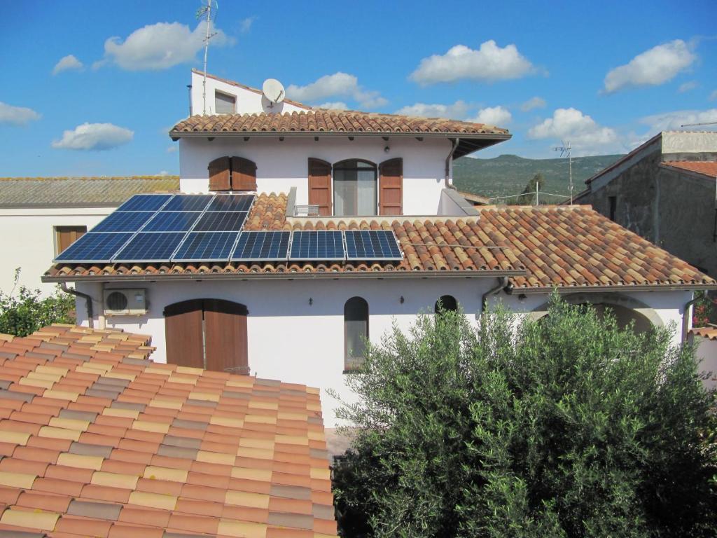 a house with solar panels on the roof at Il Portico in Uras