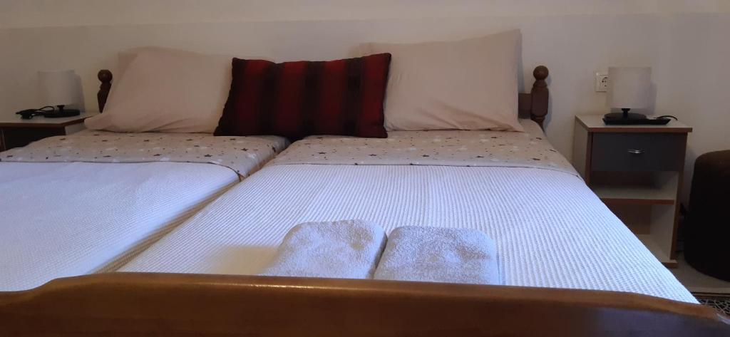 a bed with two pillows on top of it at APARTMAN Biser in Kotor