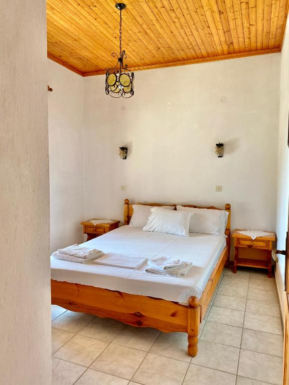 a bedroom with a bed with a wooden ceiling at Betsanis Stafylos Apartments in Stafylos