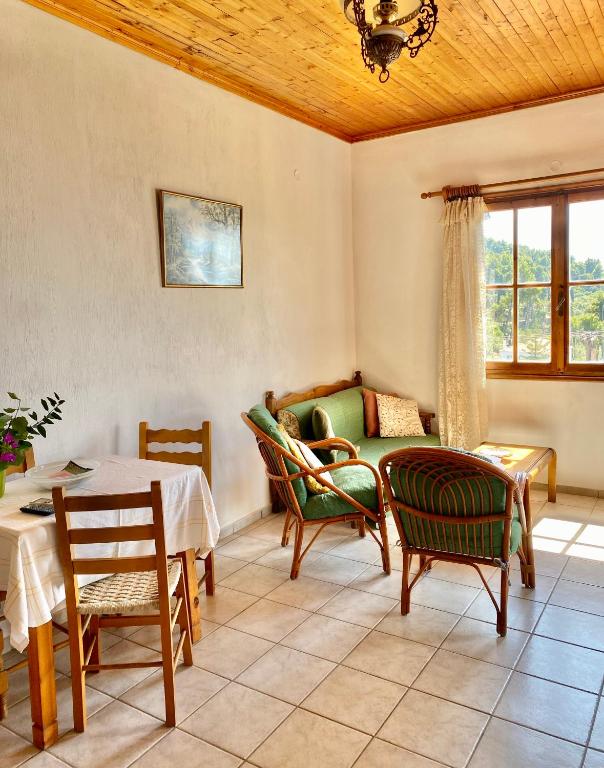 a living room with a table and chairs at Betsanis Stafylos Apartments in Stafylos