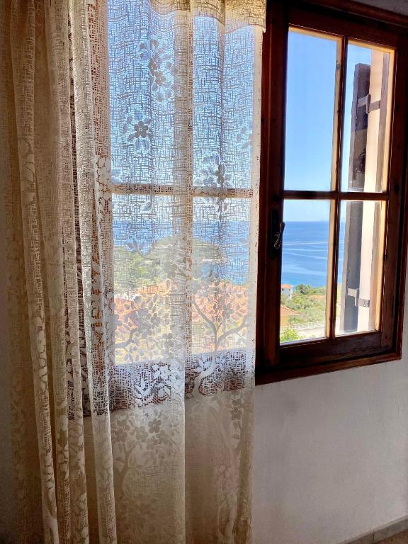 a window with a view of the ocean at Betsanis Stafylos Apartments in Stafylos