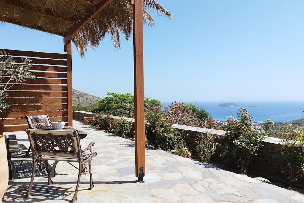 a patio with a table and a chair and the ocean at Alexandria Aegean View in Gavrio