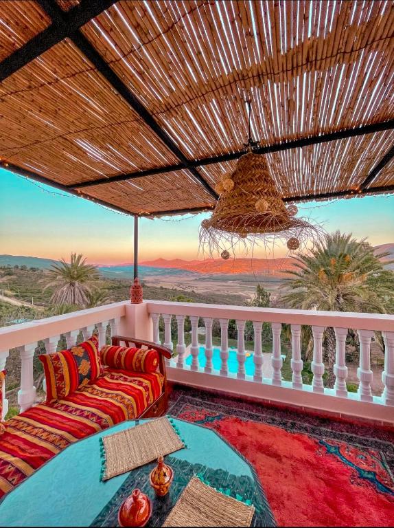 a living room with a couch on a balcony at Dar Bakkali Nadi in Tangier