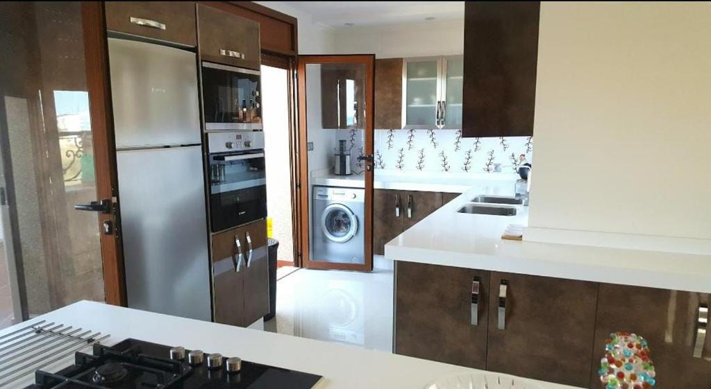 a kitchen with a refrigerator and a stove in it at اقامة نور in Nador