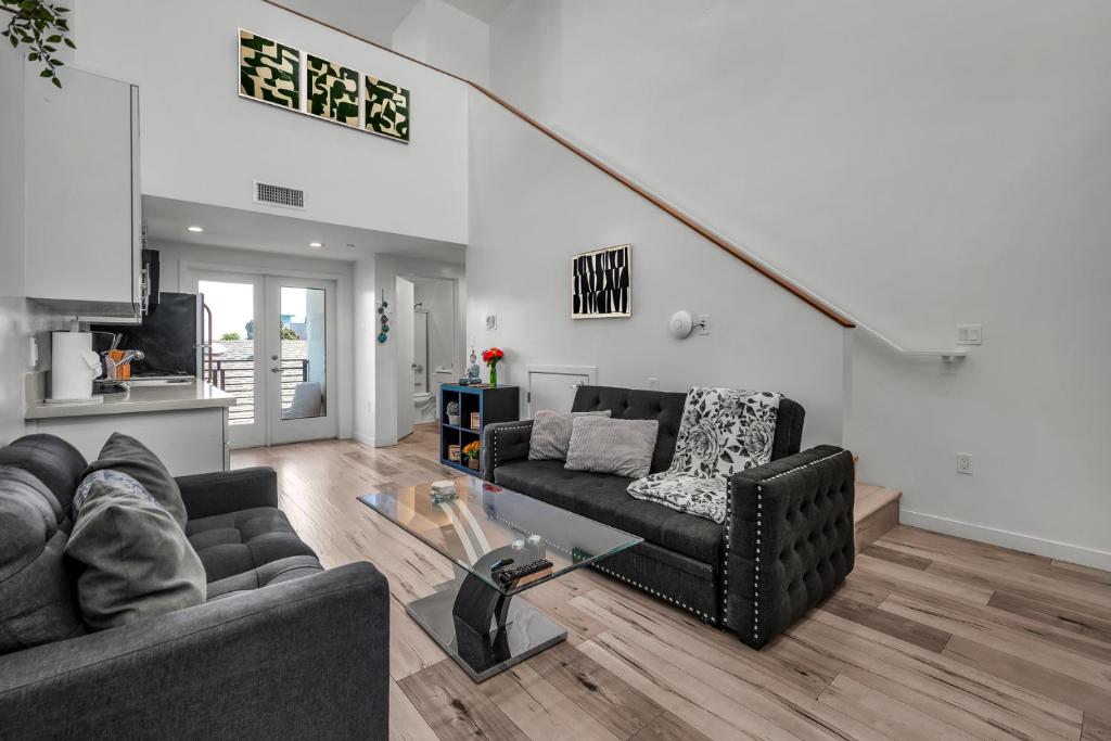 ein Wohnzimmer mit Sofa und Tisch in der Unterkunft Stylish Modern one Bedroom Hollywood Loft With in unite washer dryer & Balcony in Los Angeles