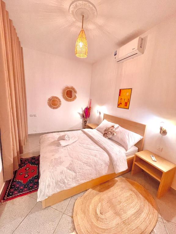 a bedroom with a bed with a cat laying on it at Dar Bakkali Nadi in Tangier