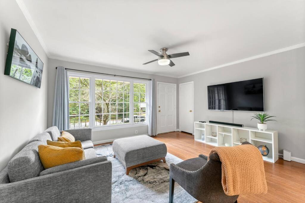 a living room with a couch and a tv at Picture-Perfect Charmer in North Decatur in Decatur