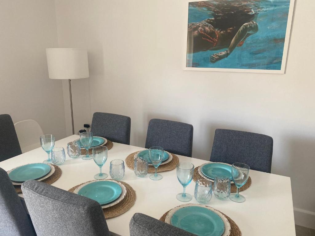 a table with plates and glasses on top of it at New Best Priced Walkable Beach Sites City Rhodes Town Apartment in Rhodes Town