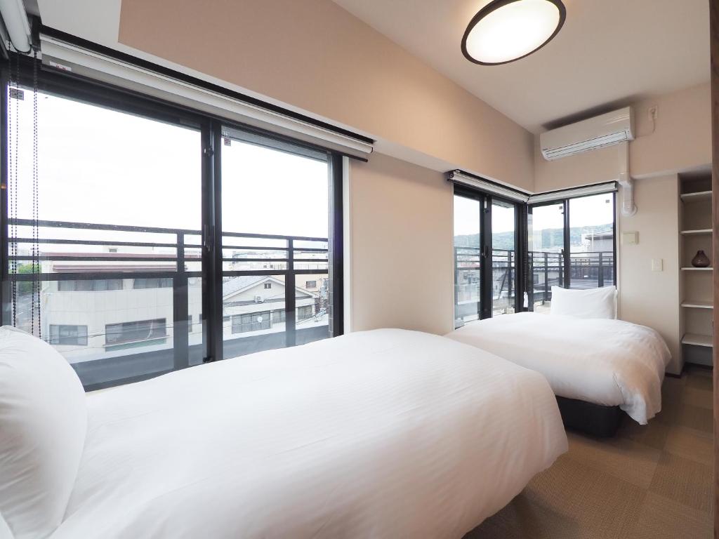 Postel nebo postele na pokoji v ubytování HIYORI Stay Kyoto Kamogawa