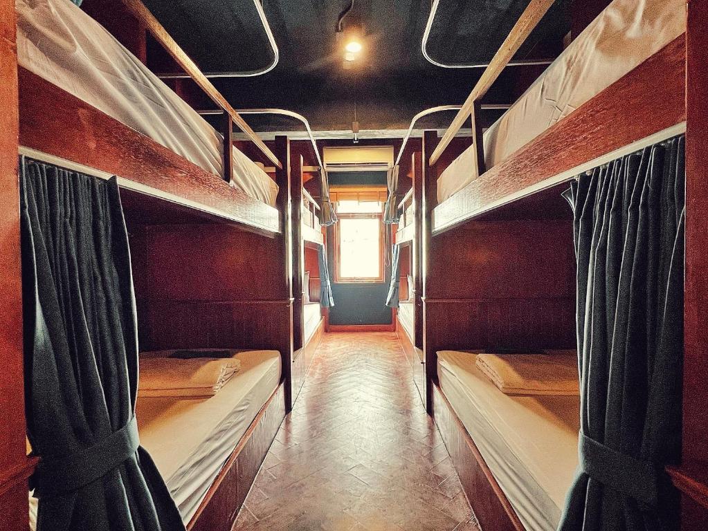 a hallway with two bunk beds in a room at Suneta Hostel Chiangmai in Chiang Mai