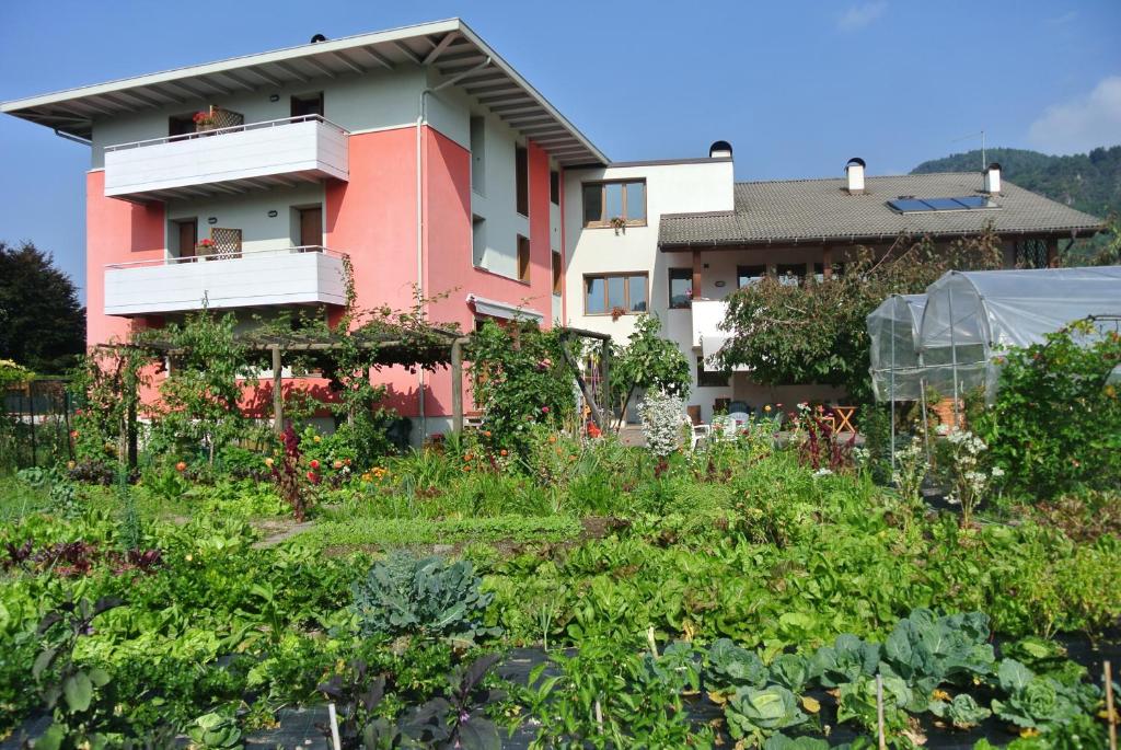 a building with a garden in front of it at Agritur Bortolotti in Pergine Valsugana