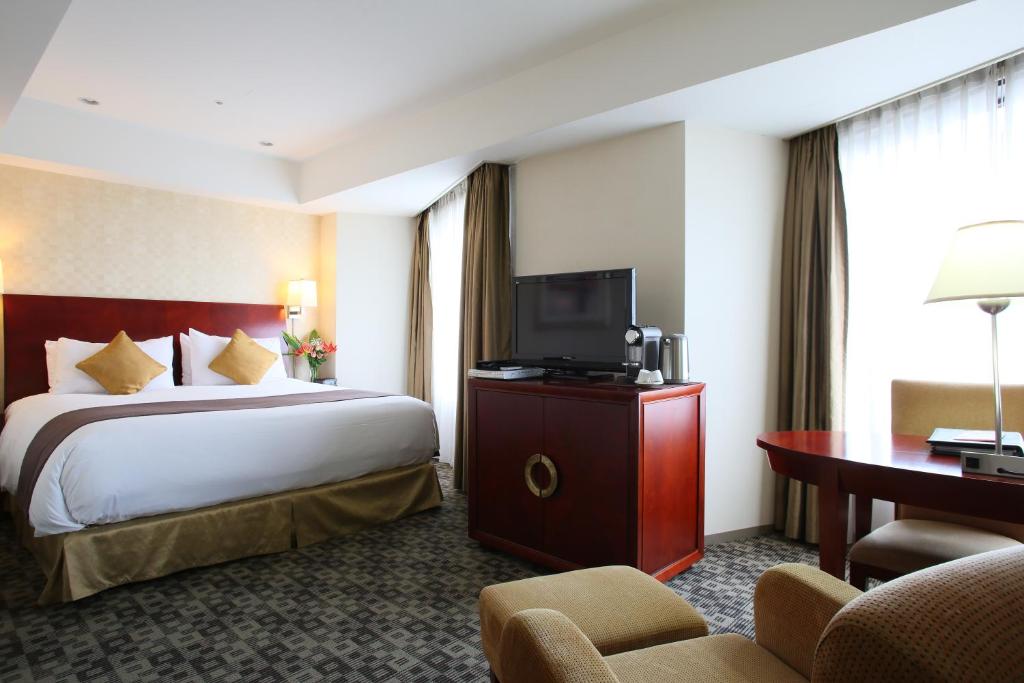 Postel nebo postele na pokoji v ubytování International Resort Hotel Yurakujo