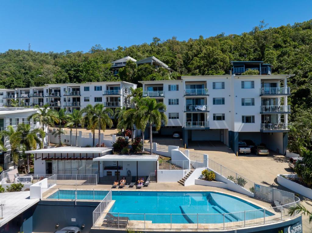 an aerial view of a resort with a swimming pool at Airlie Summit Apartments in Airlie Beach