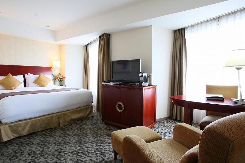 Postel nebo postele na pokoji v ubytování International Resort Hotel Yurakujo