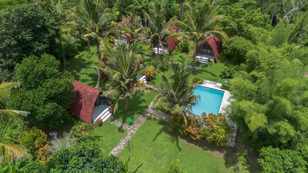 an aerial view of a house with a palm tree at Apit Lawang Villas & Resto in Nusa Penida