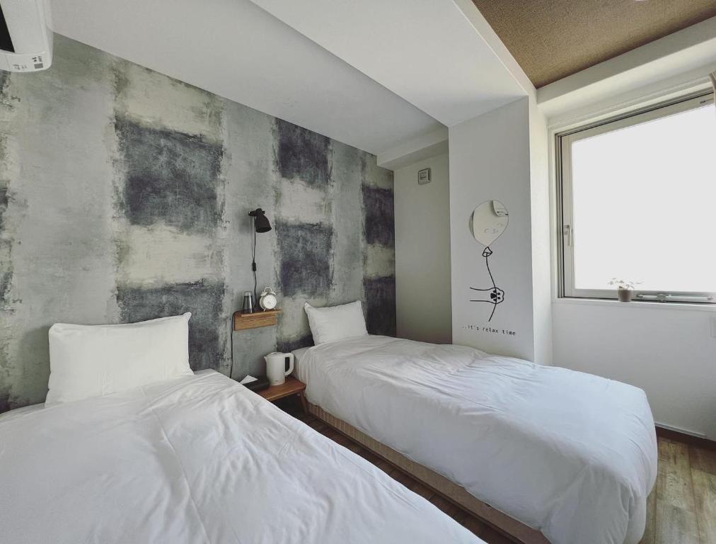 Postel nebo postele na pokoji v ubytování HOTEL WAN OSAKA EBISU