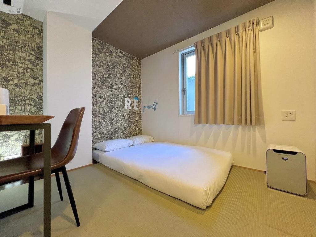 Postel nebo postele na pokoji v ubytování HOTEL WAN OSAKA EBISU