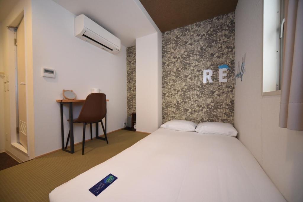 Postel nebo postele na pokoji v ubytování HOTEL WAN OSAKA EBISU