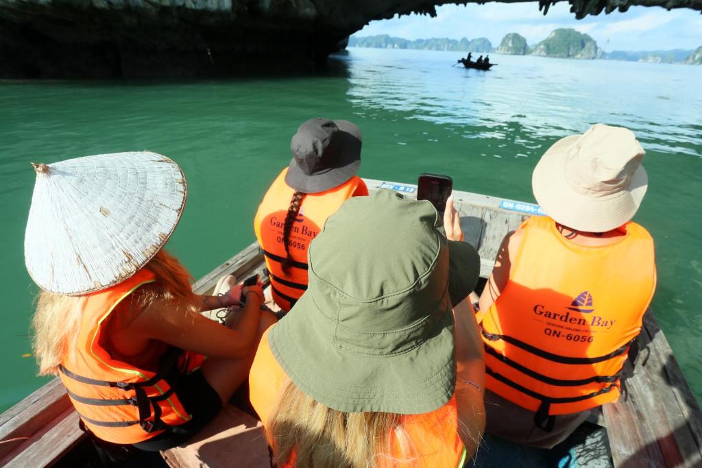 a group of people sitting in a boat on the water at Halong Luxury Cruise in Ha Long