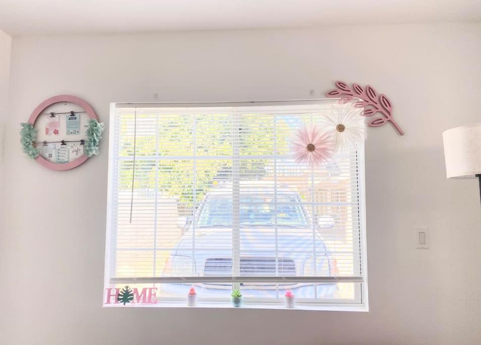 a window in a room with a car at Pink Cozy house 2 bedrooms in Rosemead