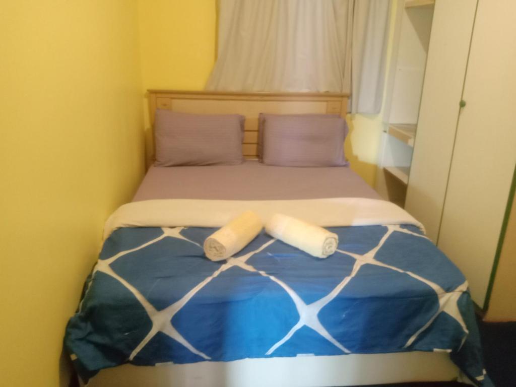 a bed with two pillows on top of it at Pd Bayu Beach Resort Apartment A2.16 in Port Dickson