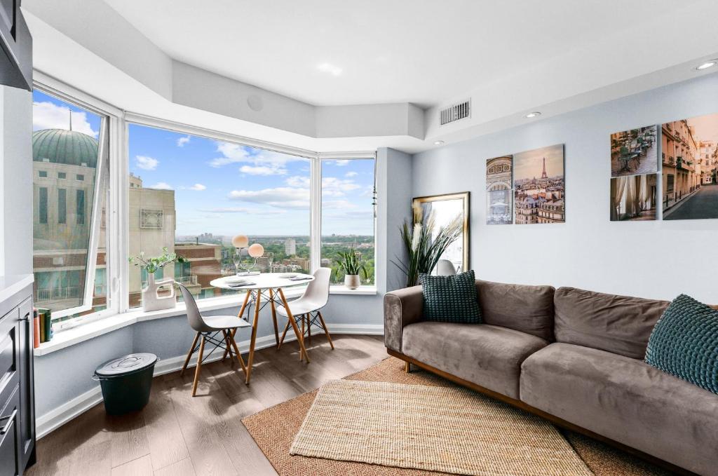 a living room with a couch and a table at Downtown Toronto Condo with Gym & Subway Access in Toronto