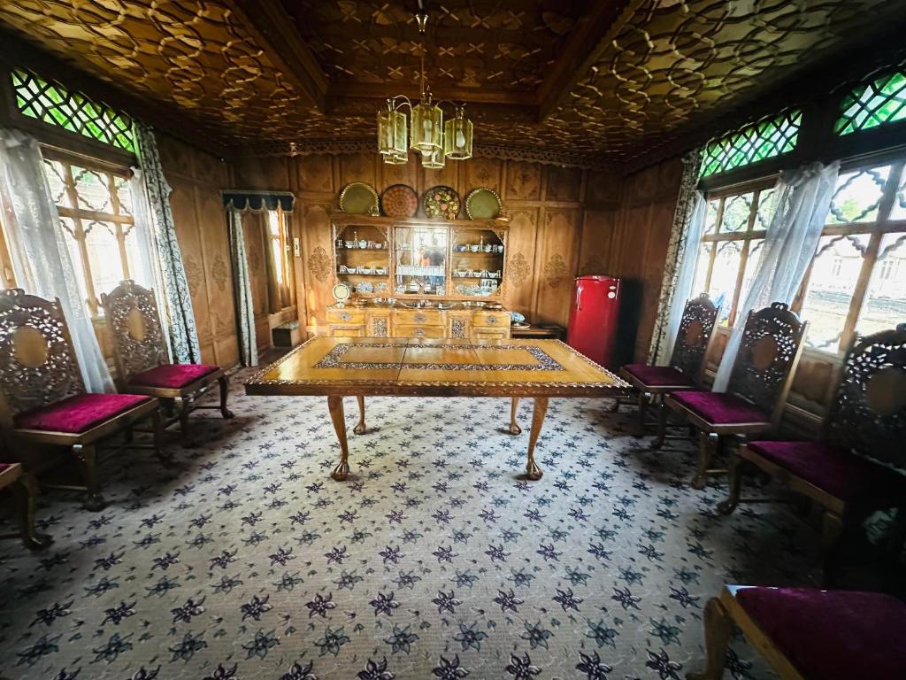 a dining room with a large table and chairs at Maharaja palace houseboat in Srinagar