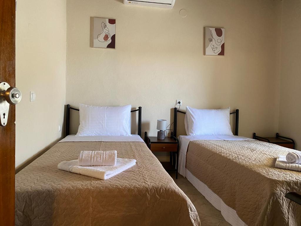 a room with two beds with towels on them at Summer Home in Potos