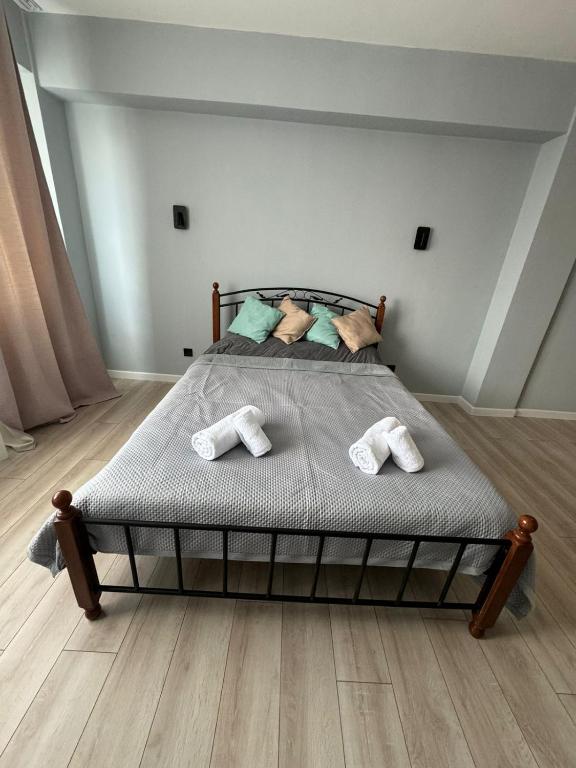 a bedroom with a bed with two slippers on it at Современная квартира в Алматы для 4 человек in Shugyla