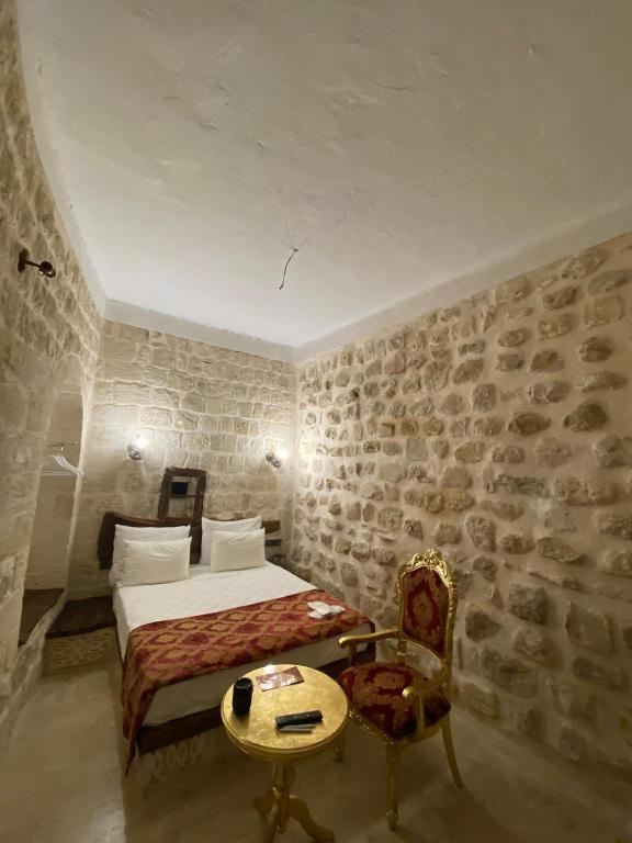 Postel nebo postele na pokoji v ubytování Antik Han Otel Mardin