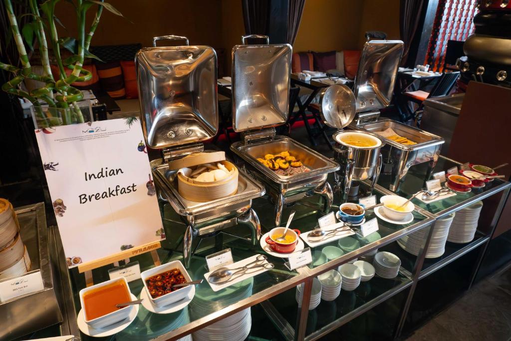 a buffet of food on a glass table with dishes at lebua at State Tower in Bangkok