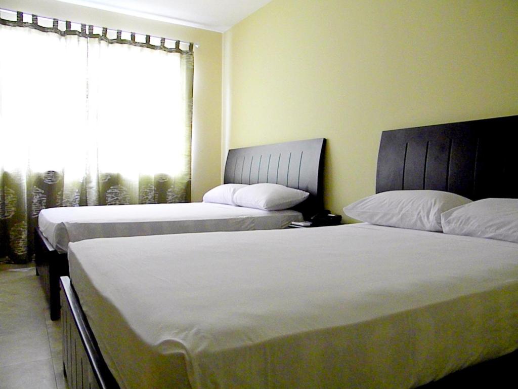 Postel nebo postele na pokoji v ubytování Hotel Marvento II