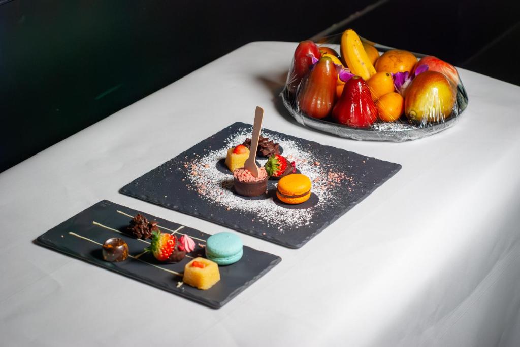two plates of food on a table with fruit at lebua at State Tower in Bangkok