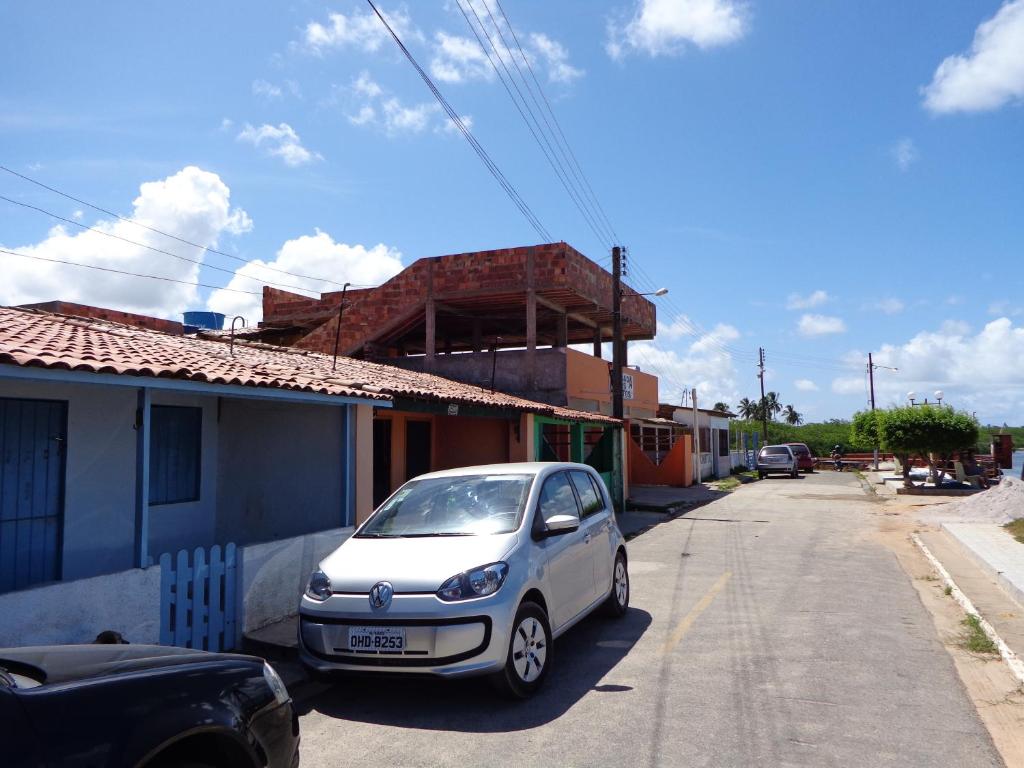 a small car parked on the side of a street at Pousada dos Ventos in Pôrto de Pedras