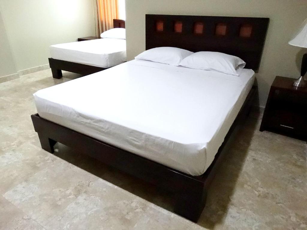 Postel nebo postele na pokoji v ubytování Hotel Marvento Suites
