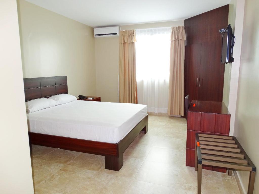 Postel nebo postele na pokoji v ubytování Hotel Marvento Suites