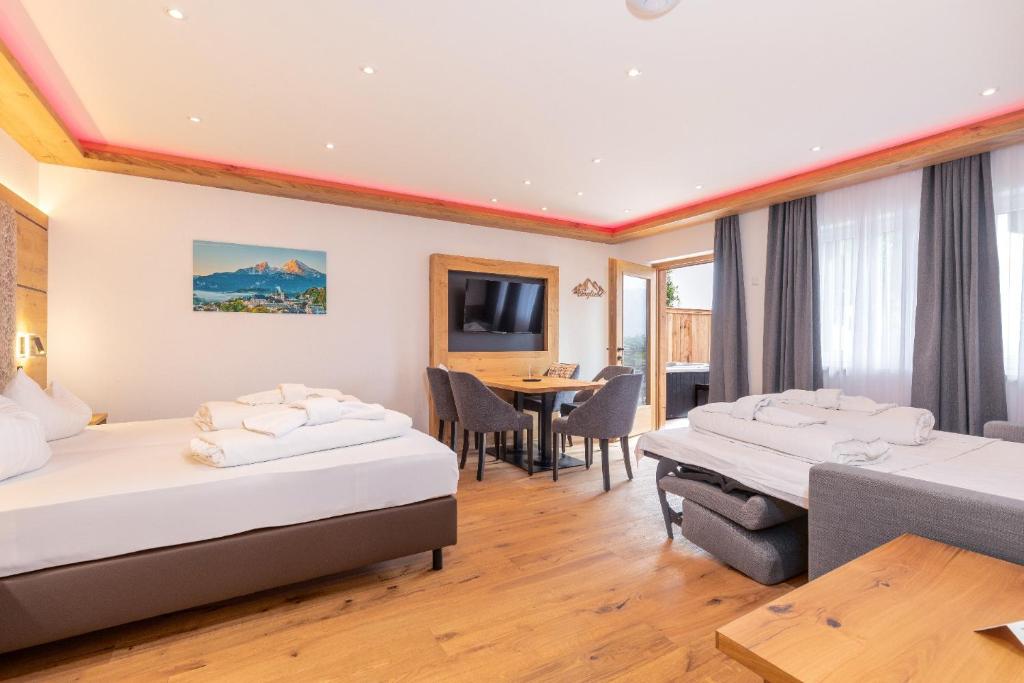 a hotel room with two beds and a table at Luxus-Appartement mit Whirlpool und Sauna #531 in Ainring