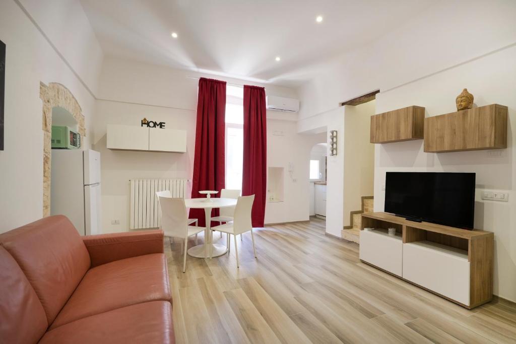 a living room with a couch and a table at La Dimora del Sole Pugliese in Casamassima