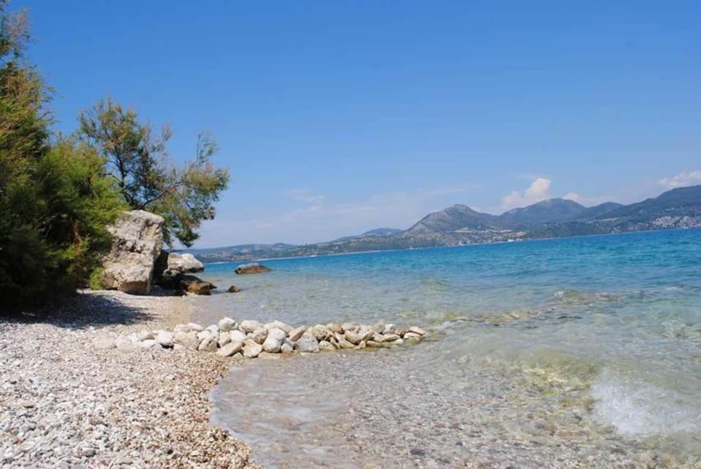 a group of rocks on the shore of a beach at thalassa home in Nikiana
