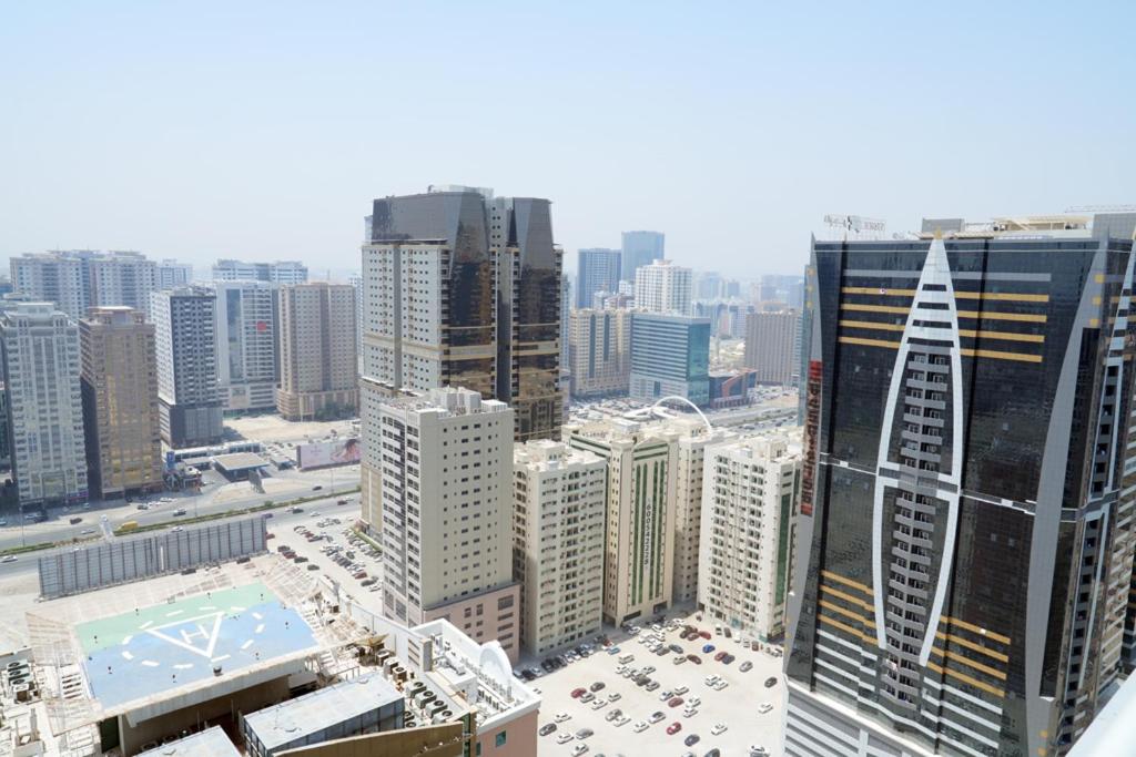 an aerial view of a city with tall buildings at Comfort in Sharjah